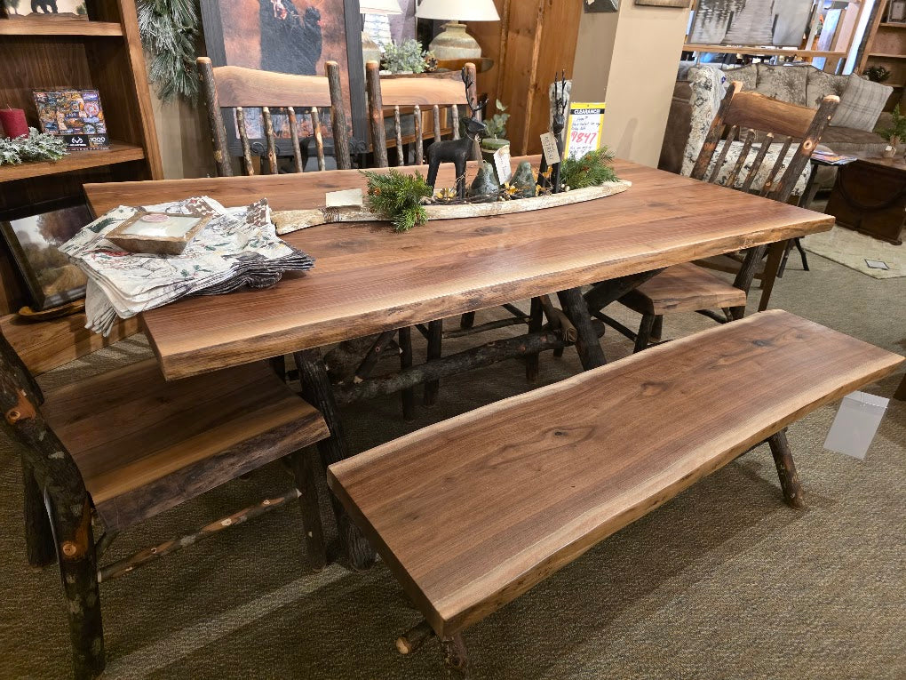 Wooden dining table with benches in a furniture store setting
