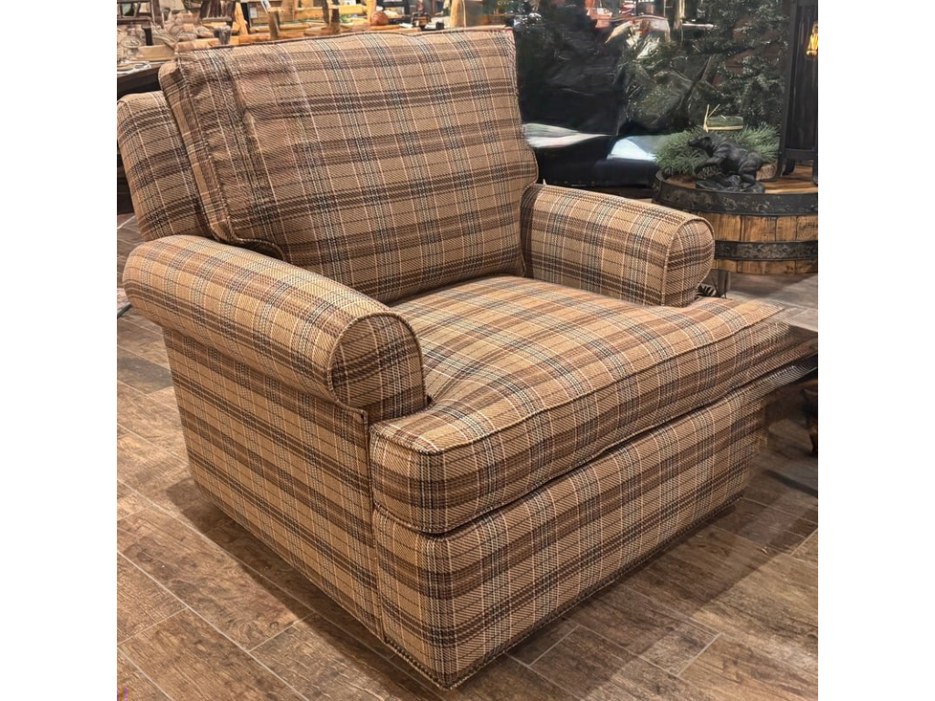 Plaid armchair on a wooden floor with a blurred background