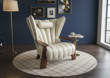 White armchair with wooden armrests in a room with blue walls and a lamp.
