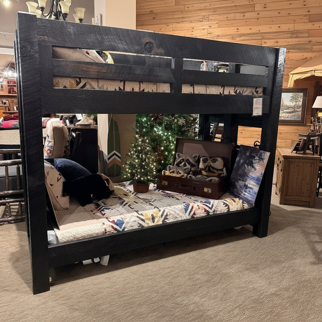 Black wooden bunk bed with colorful bedding in a store setting
